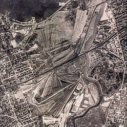 George Wilson and his wife Myrtle live in the "valley of ashes," a refuse dump (shown in the above photograph) historically located in New York City during the 1920s. Today, the area is Flushing Meadows–Corona Park.